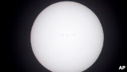 The sun, shown here shot through a white light solar filter, shows a series of sun spots as seen from Salem, Ore., Aug. 20, 2017. 