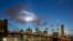 The Tribute in Light rises behind the Brooklyn Bridge and buildings adjacent to the World Trade Center complex, Sept. 10, 2014 in New York. 