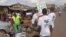 Health workers speak to people on the streets to educate them about the deadly Ebola virus in the city of Freetown, Sierra Leone, Aug. 4, 2014.