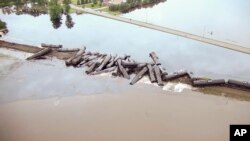 In this aerial drone image taken from video and provided by the Sioux County Sheriff's Office, tanker cars carrying crude oil are shown derailed about a mile south of Doon, Iowa, Friday, June 22, 2018.