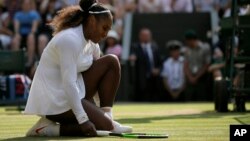 FILE - Serena Williams of the United States kneels after losing a point to Germany's Angelique Kerber during their women's singles final match at the Wimbledon Tennis Championships, in London, July 14, 2018. (AP Photo/Tim Ireland)