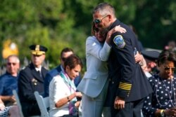 Speaker of the House Nancy Pelosi of California hugs Washington Metropolitan Police Department officer Michael Fanone, in the Rose Garden of the White House, Aug. 5, 2021.