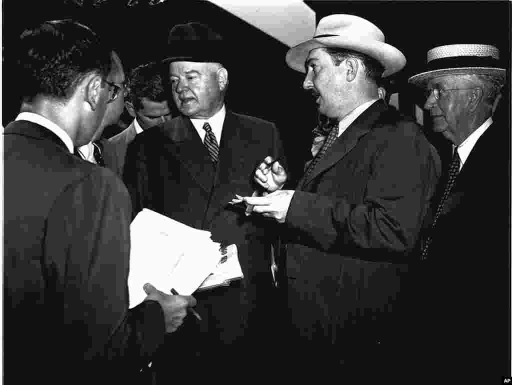 FILE - Herbert Hoover is interviewed by newsmen as he arrives in Chicago for the Republican National Convention, June 27, 1944. Thomas Dewey and John Bricker were nominated as president and vice president, respectively.