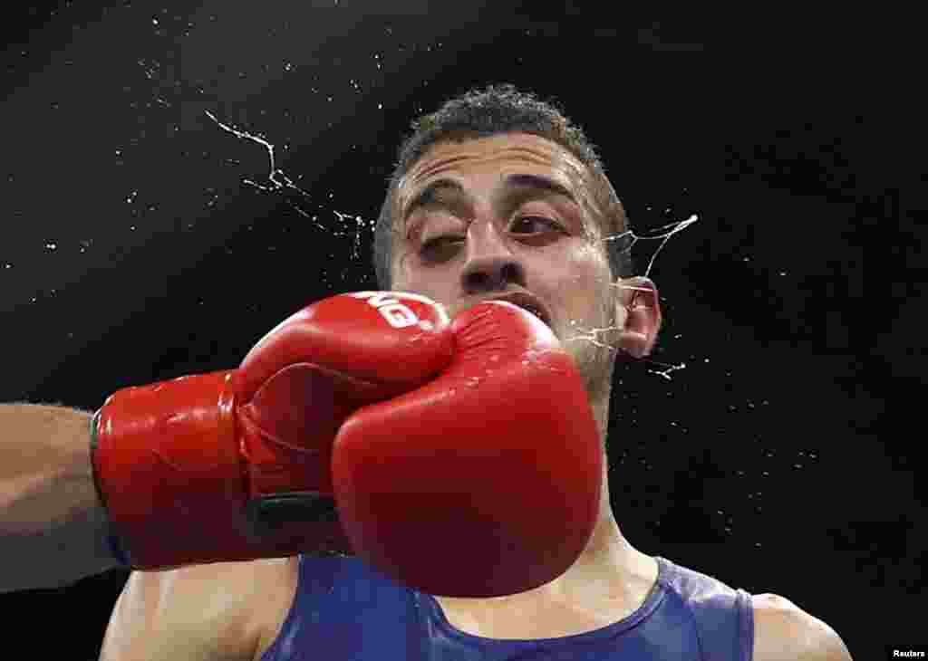 Mohamed Flissi of Algeria competes in a preliminary boxing match at the Olympics in Rio de Janeiro, Brazil.