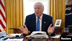 FILE - President Donald Trump is seen giving an interview in the Oval Office at the White House in Washington, Feb. 23, 2017. 