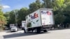 FedEx vans carrying two giant pandas sent by China arrive at the National Zoo in Washington, Oct. 15, 2024. (Teng Xu/VOA)