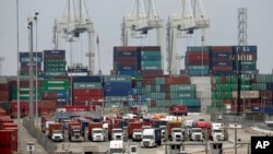 Cargo trucks wait in line at the Port of Long Beach, in Long Beach, California, Feb. 17, 2015.