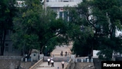 (File Photo) North Koreans walk across a bridge over the Tumen river at a border crossing with Tumen in China's Jilin province August 29, 2010. 