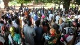 FILE - A U.N. refugee agency official speaks to civilians during a distribution of food items in Yei, in southern South Sudan, Nov. 15, 2016. The formerly peaceful town of Yei became a center of country's renewed civil war, gripped by killings among the dozens of ethnic groups.