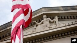 FILE - The front facade of the Robert F. Kennedy Department of Justice Building is seen in Washington, in a June 19, 2015, photo.