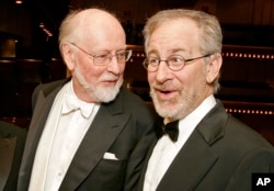 FILE - Conductor/composer John Williams appears with film director Steven Spielberg before the New York Philharmonic's Spring Gala in New York on April 26, 2006. (AP Photo/Stephen Chernin, File)