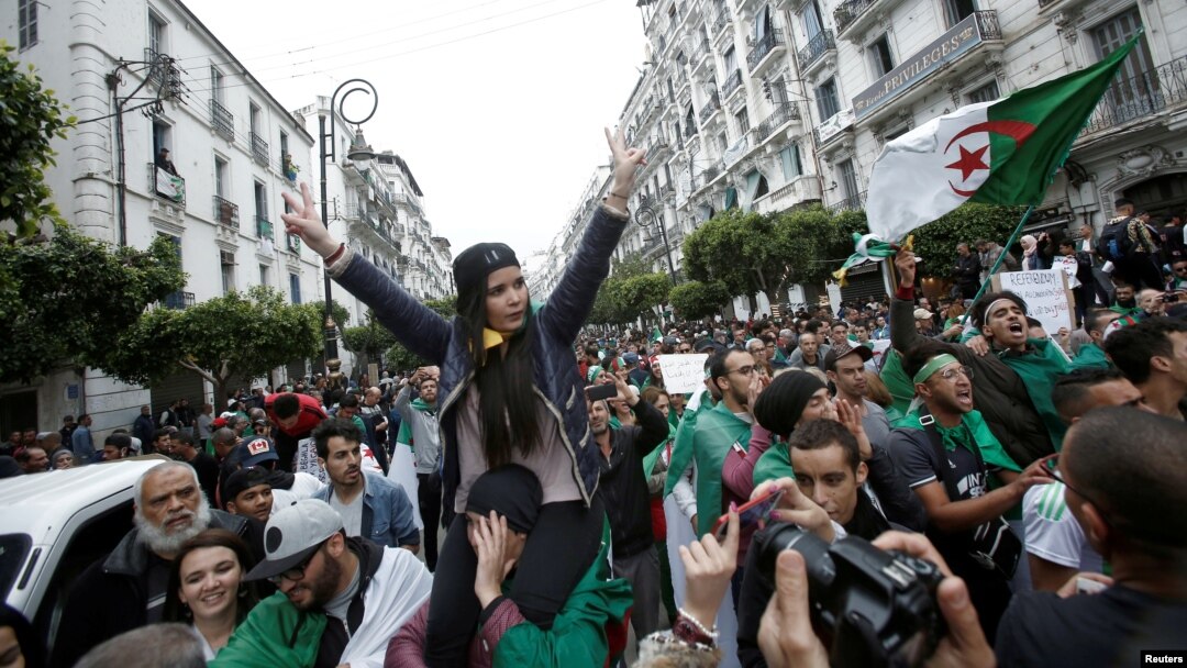 Demonstrators hold flags and banners during peaceful anti-government protests in Algiers, Algeria, May 3, 2019. 