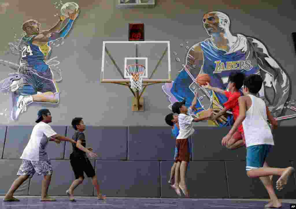 Boys plays at the &quot;House of Kobe&quot; basketball court in Valenzuela, north of Manila, Philippines. Fans left flowers and messages on the walls at the newly inaugurated court after learning of Bryant&#39;s death. Bryant died in a helicopter crash.