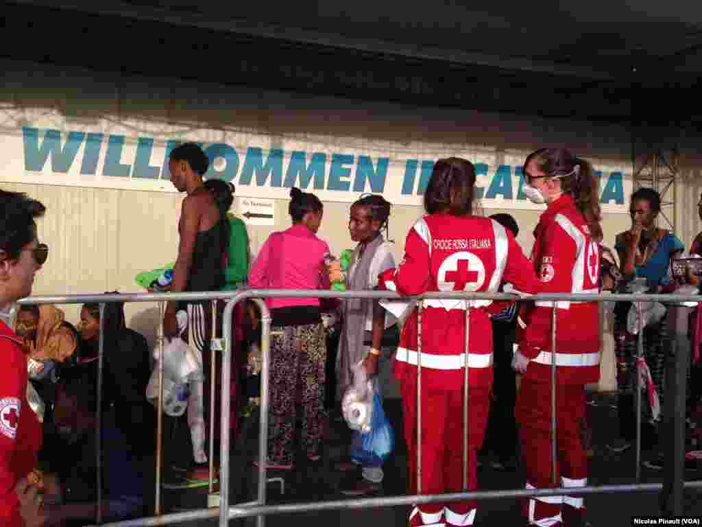 Migrants treated by Red Cross workers in Catania.