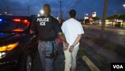 FILE - A U.S. Immigration and Customs Enforcement (ICE) officer makes an arrest. 