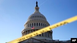 Police tape marks a secured area of the Capitol, Jan. 19, 2018, in Washington.