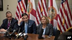 Sen. Marco Rubio, R-Fla., center, is joined by Rep. Mario Diaz-Balart, R-Fla., left, and Rep. Ileana Ros-Lehtinen, R-Fla., as they speak with a Venezuelan opposition leader via speakerphone on Capitol Hill in Washington, July 28, 2017. 