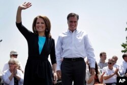 In this May 3, 2012, photo, Rep. Michele Bachmann of Minnesota joins Republican presidential candidate Mitt Romney at a campaign stop in Portsmouth, Virginia.