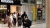 Shoppers leave a Woolworths store at a shopping centre in Lenasia, south of Johannesburg, Aug. 28, 2013. 