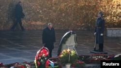 Russian President Vladimir Putin attends a wreath laying ceremony at the eternal flame during an event to commemorate the 75th anniversary of the battle of Stalingrad in World War Two, at the Mamayev Kurgan memorial complex in the city of Volgograd, Russi