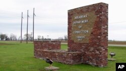 FILE - This March 25, 2017, photo shows a sign for the Department of Correction's Cummins Unit prison in Varner, Ark.