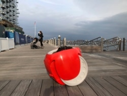 FILE - A cargo-carrying robot called the Gita sits near a waterfront park on Nov. 11, 2019, in Boston.