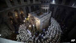 Catholic clergy walk during the Washing of the Feet procession at the Church of the Holy Sepulchre, traditionally believed by many Christians to be the site of the crucifixion and burial of Jesus Christ, in Jerusalem, March 29, 2018. 