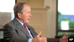 FILE - Former President George W. Bush speaks during an interview at the George W. Bush Presidential Library, in Dallas, Texas, April 18, 2018. 