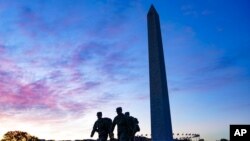 FILE - U.S. National Guard members walk toward the White House from the Washington Monument in Washington, Nov. 3, 2020.