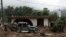 Mexico Tropical Weather: A pickup truck lays destroyed next to a house damaged by a mudslide in Xaltepec, on the mountainous north of Puebla state, Mexico, Sunday, Aug. 7, 2016. 