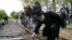A Rabbi puts a rose on the railroad tracks at former concentration camp Westerbork, the Netherlands, remembering more than a hundred thousand Jews who were transported from Westerbork to Nazi death camps, May 9, 2015.