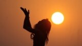 An Indian sadhu - holy man - performs yoga at sunrise at the Dashashwamedh Ghat in Varanasi.