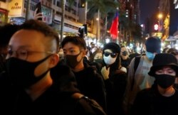 FILE - Protesters attend a Human Rights Day march, organized by the Civil Human Rights Front, in Hong Kong, Dec. 8, 2019.