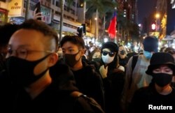 FILE - Protesters attend a Human Rights Day march, organized by the Civil Human Rights Front, in Hong Kong, Dec. 8, 2019.