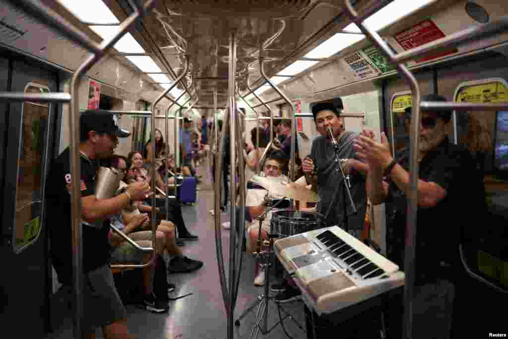 People play instruments in a subway, in the aftermath of a large power outage in Santiago, Chile.