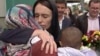 In this image made from video, New Zealand's Prime Minister Jacinda Ardern, center, hugs and consoles a woman as she visited Kilbirnie Mosque to lay flowers among tributes to Christchurch attack victims, in Wellington, March 17, 2019.