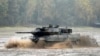 FILE - A Leopard 2 tank crosses a river during a German army, the Bundeswehr, training and information day in Munster, Germany, Oct. 9, 2015.