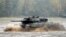 FILE - A Leopard 2 tank crosses a river during a German army, the Bundeswehr, training and information day in Munster, Germany, October 9, 2015.
