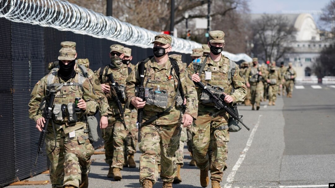 National Guard soldiers walk near the Capitol, March 4, 2021, on Capitol Hill in Washington.
