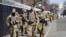 National Guard soldiers walk near the Capitol, March 4, 2021, on Capitol Hill in Washington.