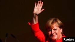 German Chancellor Angela Merkel, top candidate for the upcoming general elections of the Christian Democratic Union party (CDU), waves to supporters during an election campaign rally in Bitterfeld-Wolfen, Germany, August 29, 2017.