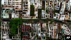 FILE - Homes stand abandoned due to ground subsidence caused by the Braskem mine in Maceio, Alagoas state, Brazil, March 6, 2022. 