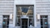 FILE - The door of the U.S. Agency for International Development, or USAID, is seen with the sign and logo removed from the wall outside of the agency's headquarters in Washington, Feb. 7, 2025.