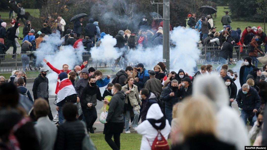 Para demonstran bubar setelah polisi melemparkan granat kejut dalam aksi protes di Minsk, Minggu (11/10). 