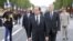France's President Francois Hollande (C), Prime Minister Jean-Marc Ayrault (2ndR) and Junior Minister for Veterans Kader Arif (2dnL), walk on the Champs-Elysees avenue during the annual Bastille Day military parade in Paris, on July 14, 2012
