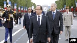 Tổng thống Pháp Hollande (giữa) cùng Thủ tướng Ayrault và Bộ trưởng Arif đi trên đại lộ Champs-Elysees trong cuộc diễu hành quân sự hàng năm nhân ngày Quốc Khánh ở Paris, 14/7/2012