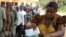 A woman casts her vote in a ballot box n empty ballot box at Agulu in Anambra State on February 6, 2010.
