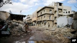 Syrian army soldiers patrol the east Aleppo neighborhood of Tariq al-Bab, Syria, Dec. 3, 2016. Tariq al-Bab was captured by Syrian government forces on Friday.