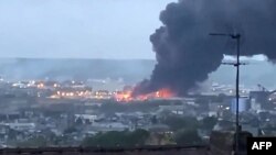 In this grab of a video taken from the Twitter account of Jean-Jacques Ganon, Sept. 26, 2019, in Rouen, smoke billows from a Seveso classified Lubrizol factory on fire. 