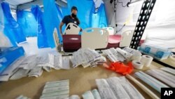 Medical supplies are lined up on shelf at one of the 32-bed Samaritan's Purse Emergency Field Hospital set up in one of the University of Mississippi Medical Center's parking garages, Aug. 17, 2021, in Jackson, Miss. 